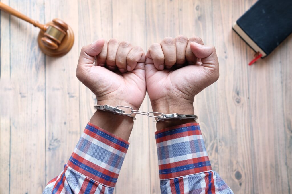 hands of a man with handcuffs close up.
